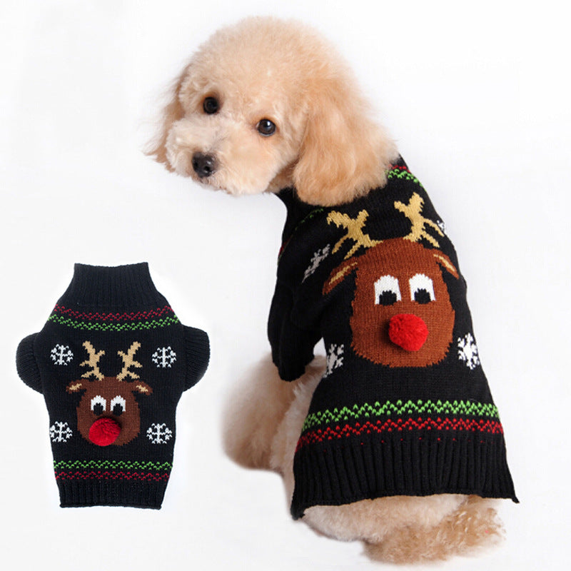 Caniche con el jersey negro de reno, junto al jersey extendido