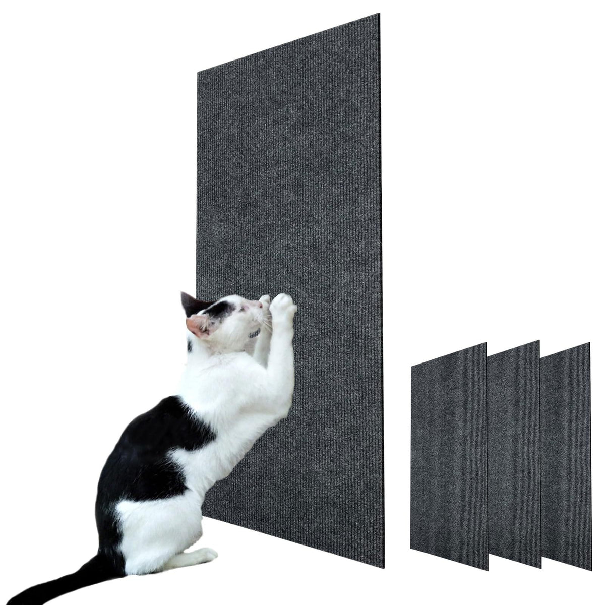 Gato blanco y negro arañando el rascador adhesivo gris oscuro pegado en la pared