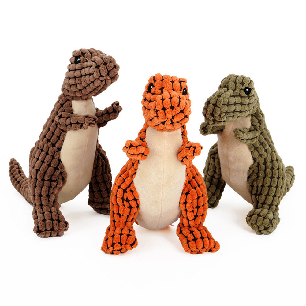 Perro jugando con el dinosaurio de peluche