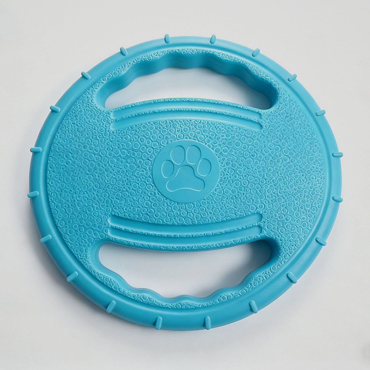 Frisbee blando azul visto de frente con el relieve y la huella central